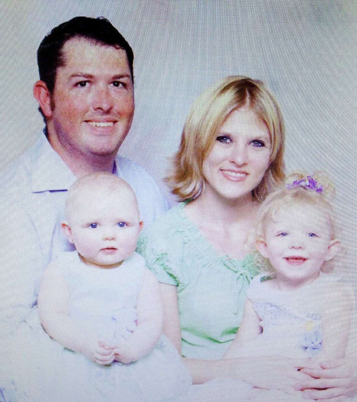 Tanner Hunt, top left, with his girlfriend and two daughters in a family portrait from 2006 that is part of the probate case file.