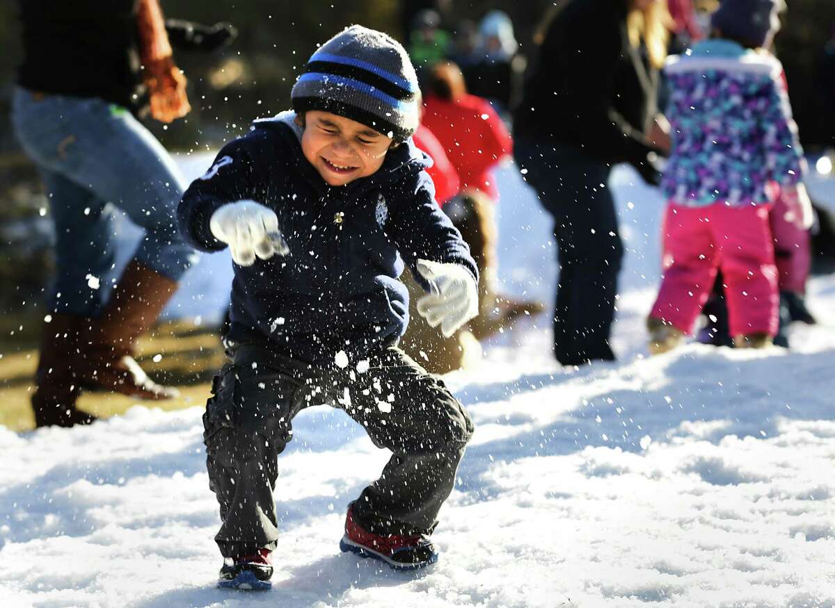 Eriq Gonzalez, 3, winces as he is hit with a snow ball from a fellow preschool student. Students at Sunshine Cottage had a Snow Day with more than 12,000 lbs. of snow (shaved ice from Pure Party Ice) blown in. The kids enjoyed northern winter activities like sledding, making snow angels, snowball throwing all capped off with marshmellows, s'mores, and hot chocolate. Friday, Jan. 16, 2015.