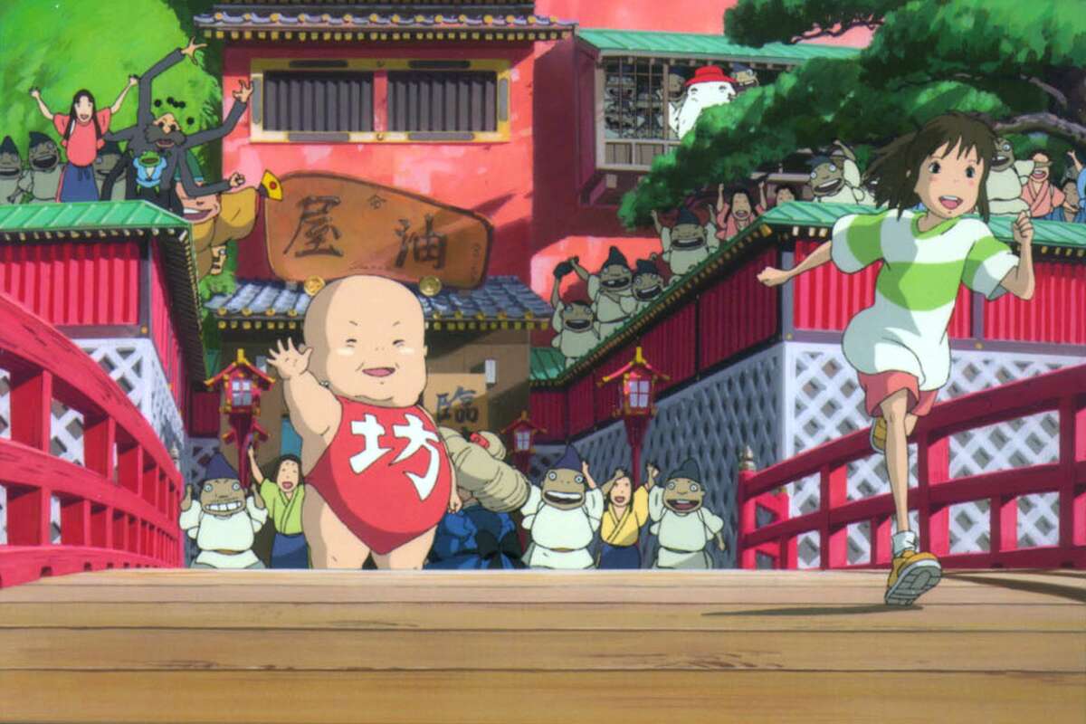 Yubaba's giant baby boy, Boh, and the workers at the bathhouse give Chihiro a big send-off in "Spirited Away," a animation by acclaimed Japanese filmmaker Hayao Miyazaki.