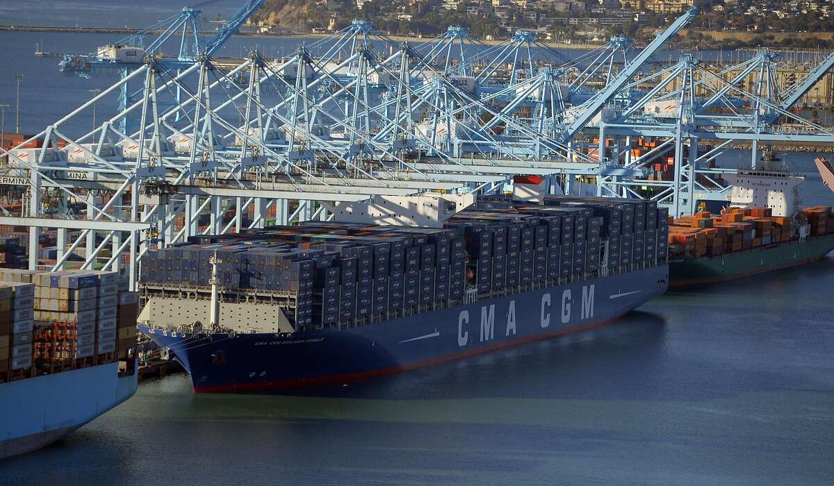 The largest container ship to ever make port in North America unloads its cargo in the Port of Los Angeles in San Pedro, Calif., on Saturday, Dec. 26, 2015. After making its maiden voyage from China, where it was built, the CMA CGM Benjamin Franklin arrived before dawn with its cargo. The ship can carry 18,000 twenty-foot equivalent units (TEUs), which is about a third more than the ships that currently dock in the Port of L.A. The vessel measures 1,300 feet long, 177 feet wide and is 197 feet tall and is staffed with a crew of 26. The giant ship is scheduled to leave Los Angeles on Wednesday, December 30 en route to Oakland before returning to China. (Scott Varley/ The Daily Breeze via AP, Pool)