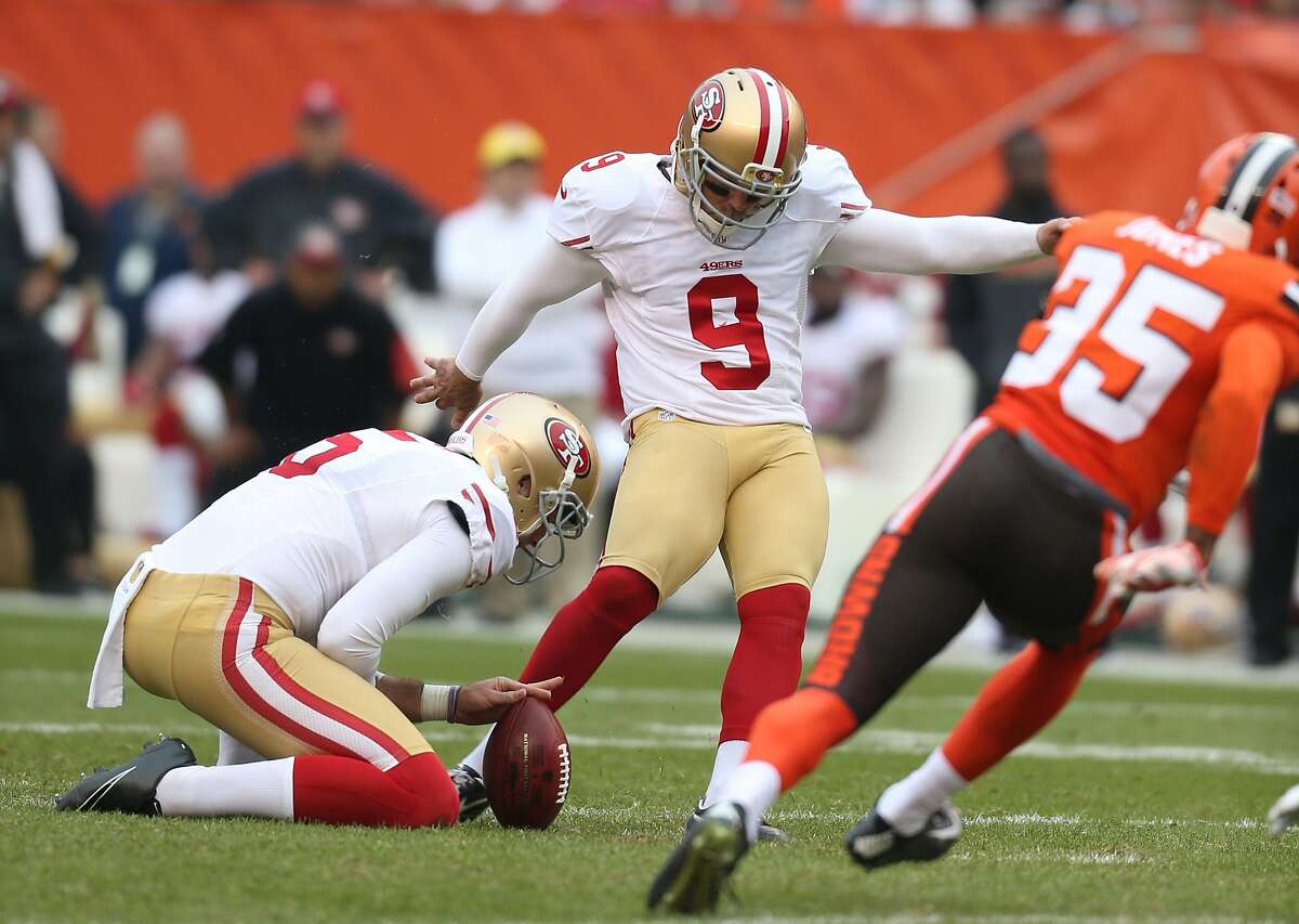 San Francisco 49ers kicker Phil Dawson (9) kicks out of the hold of punter Bradley Pinion (5) against the Cleveland Browns during the first half of an NFL football game, Sunday, Dec. 13, 2015, in Cleveland. (AP Photo/Ron Schwane)