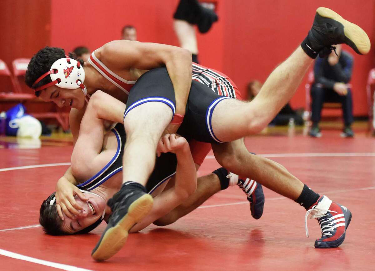 Greenwich’s Bryce Stanback takes down Darien’s Stephen Cavoli in the 138-pound bout of the high school wrestling match between Greenwich, Fairfield Warde, Staples and Darien at Greenwich High School on Wednesday.