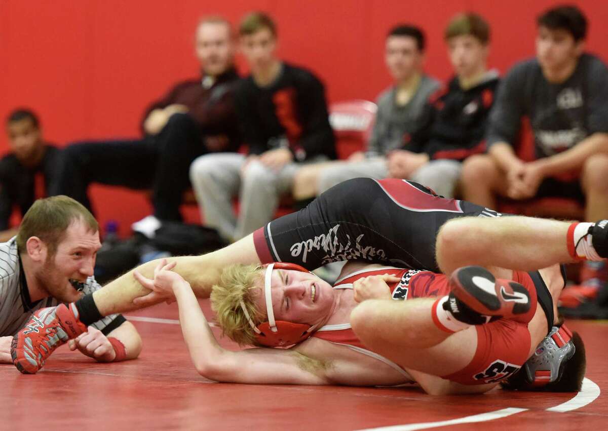 Greenwich’s Wyndsor Doyle tries to avoid getting pinned by Fairfield Warde’s Alex Steele in the 126-pound bout. Warde took first place in the quad match.