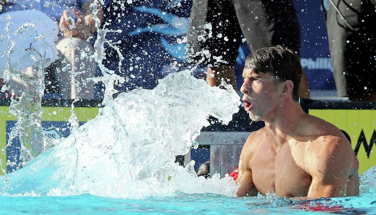 Michael Phelps reacts after competing in the men's 100-meter butterfly during the 2015 Phillips 66 National Championships held Saturday Aug. 8, 2015 at the Northside Swim Center. Phelps finished first with a time of 50.45. Jack Conger finished second with a time of 51.33. David Nolan finished third with a time of 52.15.