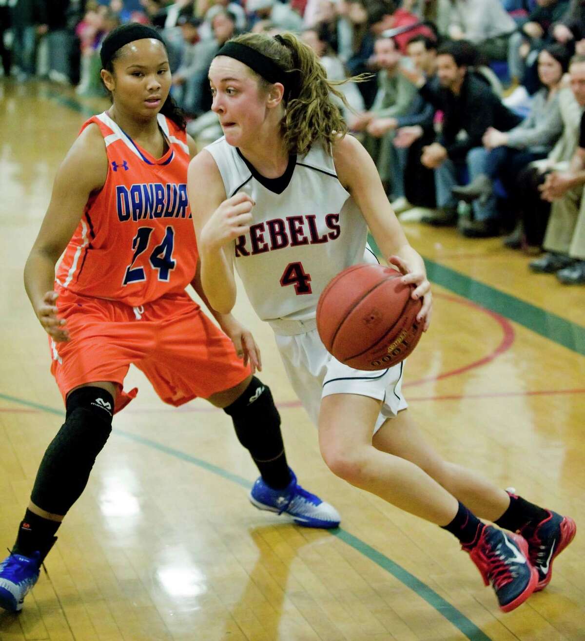 Danbury High’s Ty'Lynn Ith, left, tries to block New Fairfield’s Bridget Zima in the News-Times Greater Danbury Holiday Festival championship game Wednesday at the Danbury War Memorial. The Rebels won 70-28 and Zima earned tournament MVP honors.