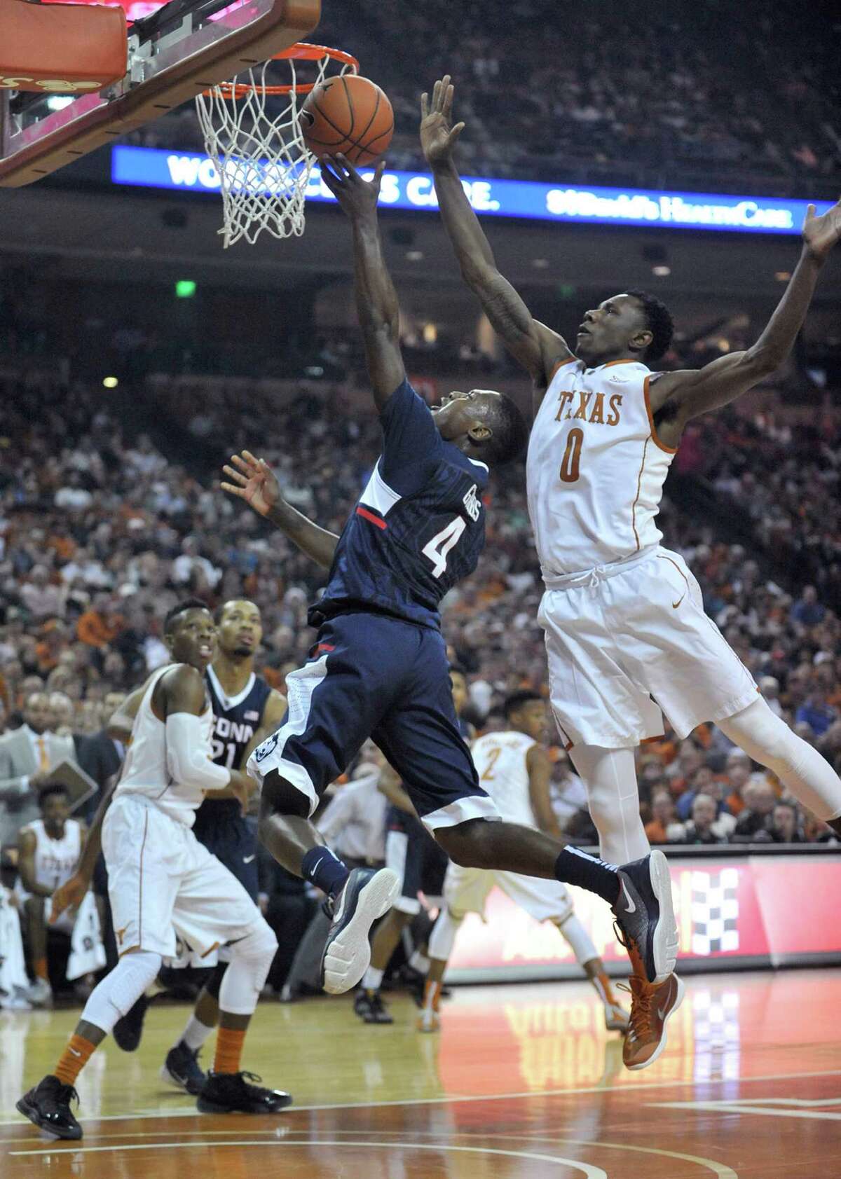 Connecticut Huskies guard Sterling Gibbs (4) drives to the basket as Texas Longhorns guard Tevin Mack (0) defends on Tuesday, Dec. 29, 2015, at the Frank Erwin Center in Austin, Texas. (Brad Horrigan/Hartford Courant/TNS)