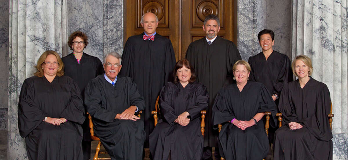 The Washington state Supreme Court as composed in 2015. From left: Justice Mary Fairhurst, Justice Sheryl Gordon McCloud, Associate Chief Justice Charles Johnson, Justice Charles Wiggins, Chief Justice Barbara Madsen, Justice Steven Gonzalez, Justice Susan Owens, Justice Mary Yu and Justice Debra Stephens. Two of the justices have since retired.