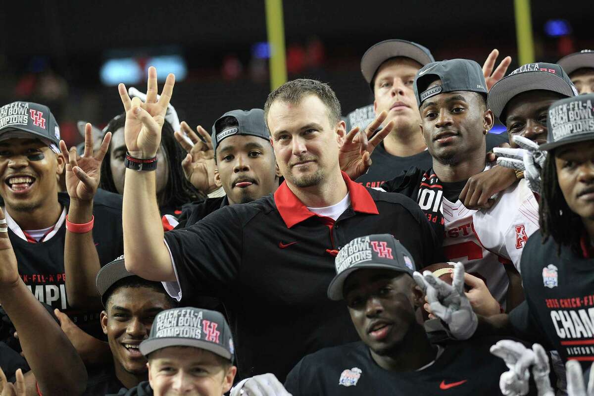 Houston Cougars head coach Tom Herman poses for a photos with his team after the Chick-fil-A Peach Bowl at the Georgia Dome on Thursday, Dec. 31, 2015, in Atlanta. Houston beat Florida State University 38-24.
