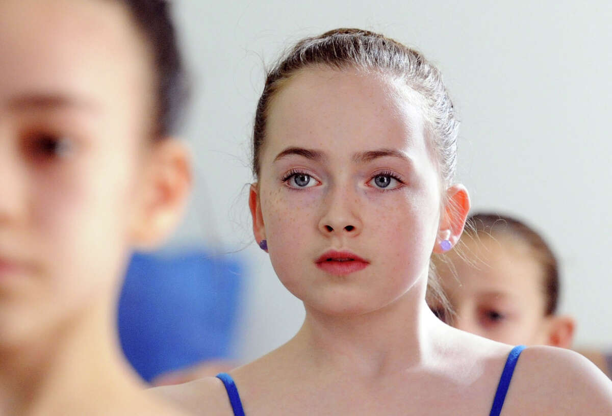 Greenwich Academy Ballerina Natalie Majd, 12, of Darien, dances with girls trying out for the Greenwich Balllet Academy at the academy in Port Chester, NY, Saturday morning, January 17, 2015. Marisol Rivera-Thurman, president and Chairman of the Board of Greenwich Ballet Academy, says the academy both provides pre-professional training and encourages young dancers to reach their maximum potential in classical ballet or contemporary dance. Rivera-Thurman said girls trying out for the academy will be notified in a few weeks if they've been selected.