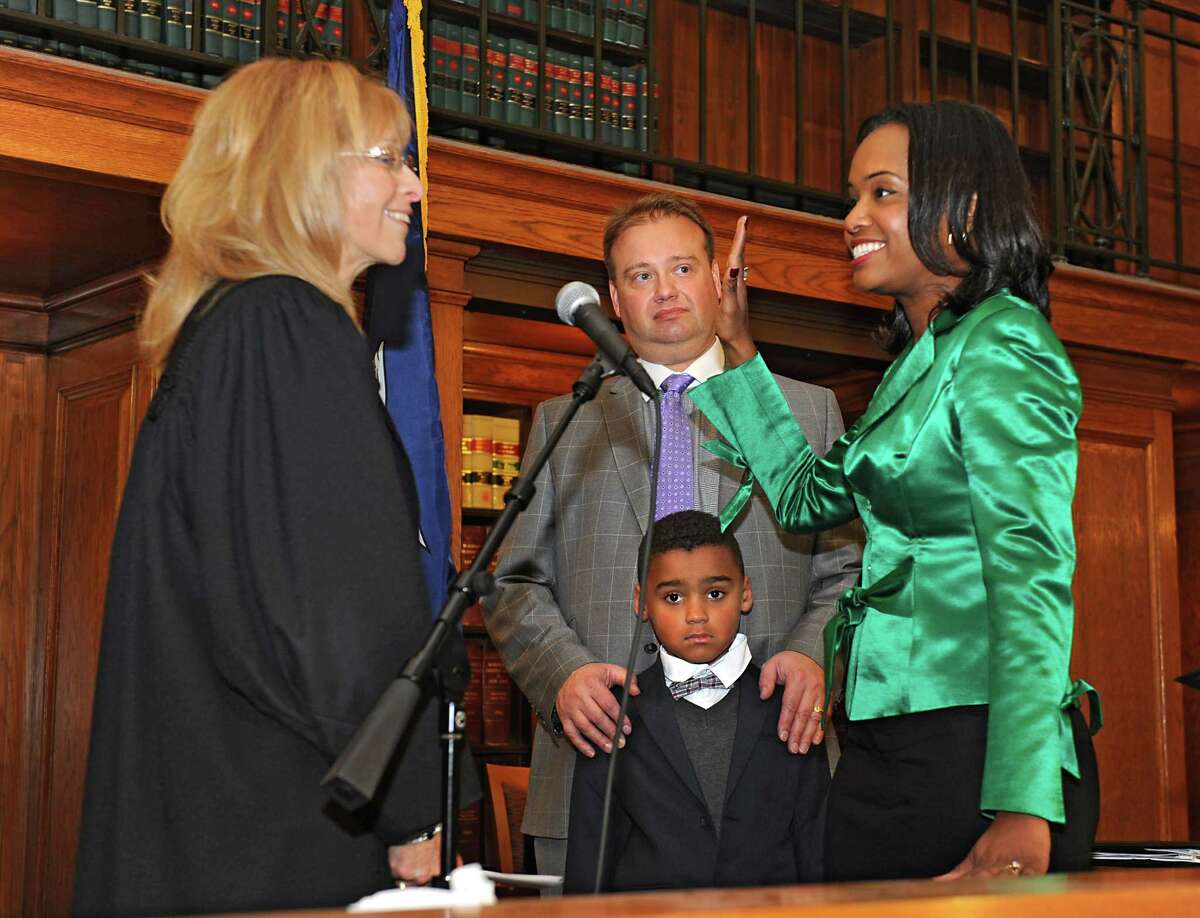 Hon. Rachel Kretser, left, administers the oath of office to state Supreme Court Justice Christina Ryba at the Albany County Courthouse on Thursday, Dec. 31, 2015 in Albany, N.Y. Ryba's husband Joel and son Graham stand by her side. She becomes the first African-American woman elected to the Supreme Court bench in the 3rd Judicial District. (Lori Van Buren / Times Union)