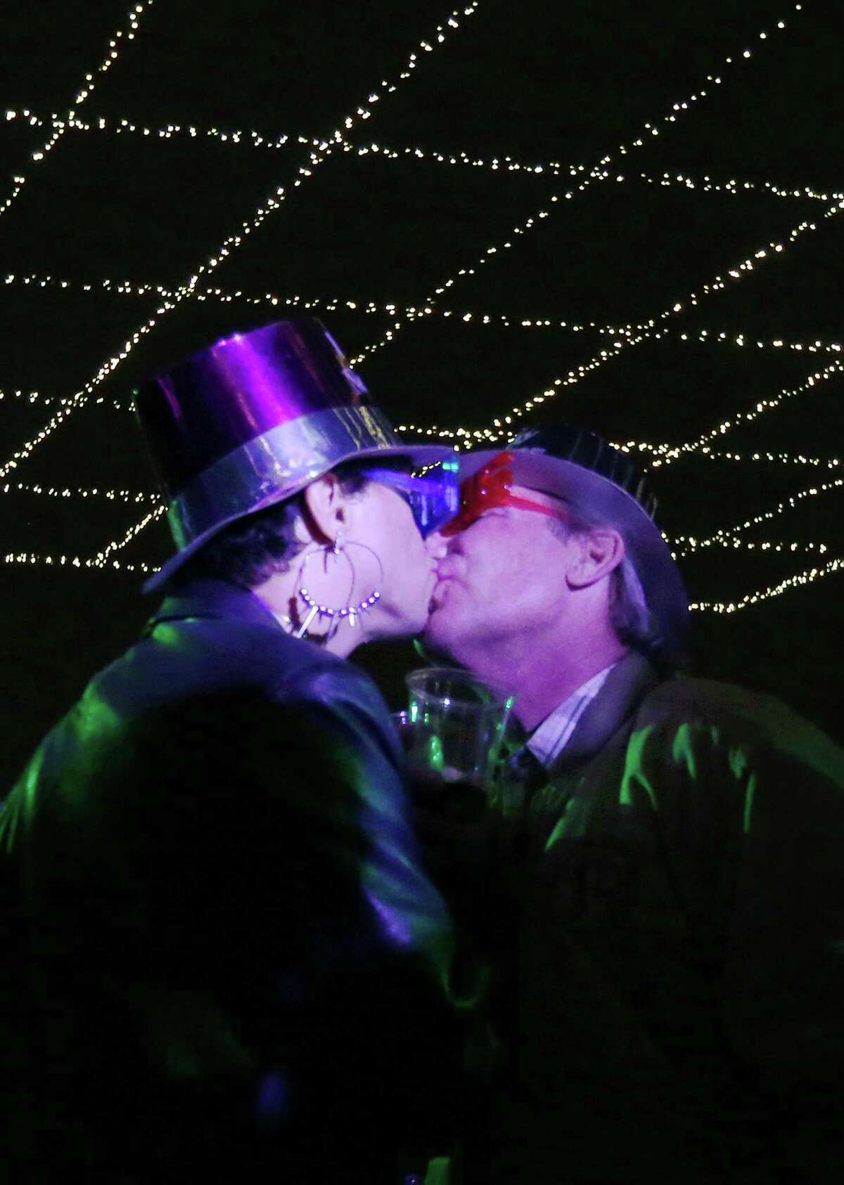 Rene Sosa kisses Theodore Kulikovski at Houston's New Year's Eve party downtown on Thursday. 