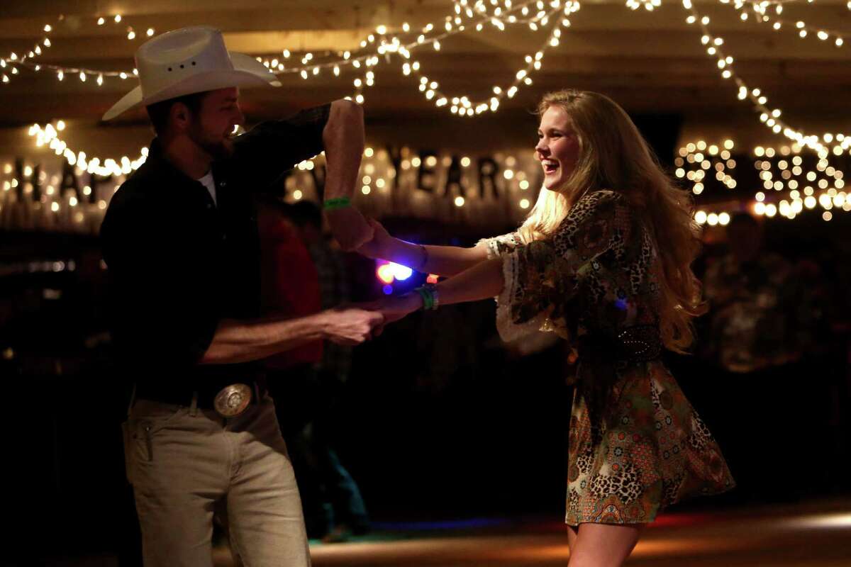 Patrons dance to country music on New Year's Eve at Tin Hall in Cypress, Texas.