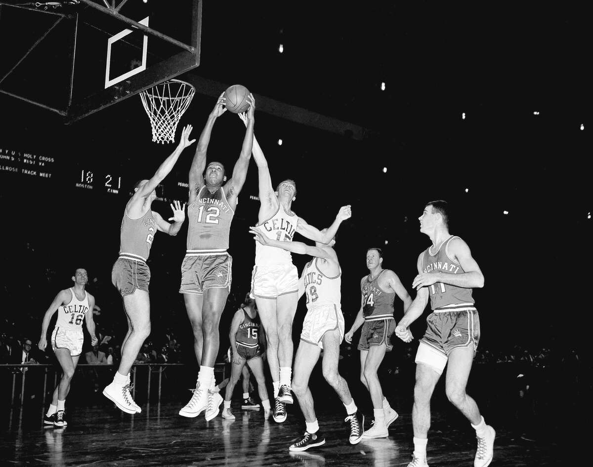 Maurice Stokes (12) of Cincinnati battles the Celtics’ Tommy Heinsohn for a rebound in February 1958 at New York’s Madison Square Garden. The following month, his career would end abruptly.