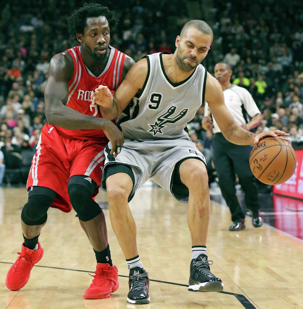 Spurs’ Tony Parker looks for room around Houston Rockets’ Patrick Beverley during second half action on Jan. 2, 2016 at the AT&T Center.