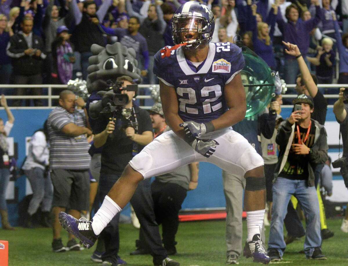 TCU running back Aaron Green celebrates after scoring a touchdown with just over three minutes to go in the fourth quarter to pull TCU to within a field goal of Oregon in Valero Alamo Bowl action in the Alamodome on Jan. 2, 2015. TCU won, 47-41.