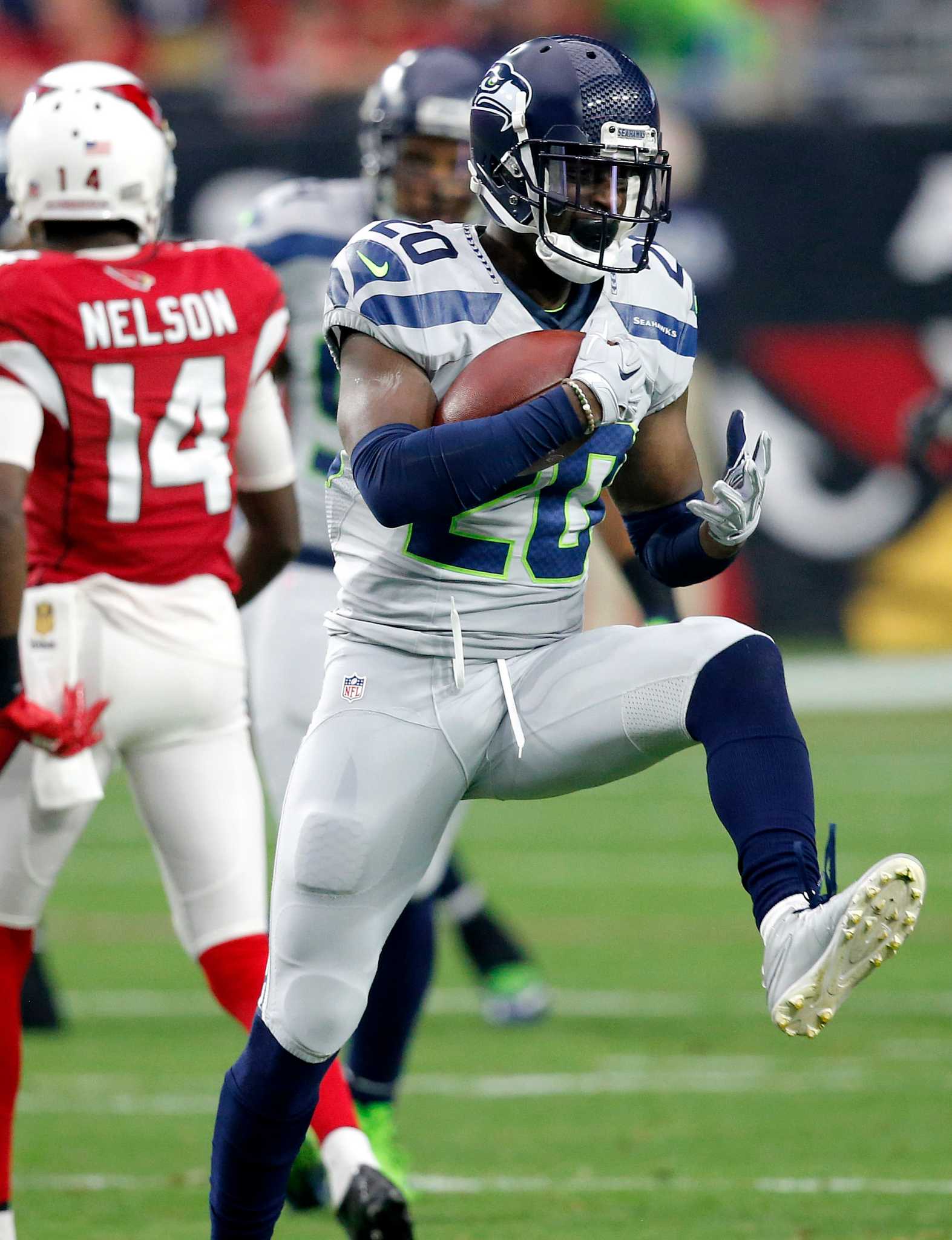 Seattle Seahawks strong safety Kam Chancellor (31)(R) celebrates his  interception with free safety Earl Thomas (29) with cornerback Richard  Sherman (25) and outside linebacker K.J. Wright (50) near by during the  first