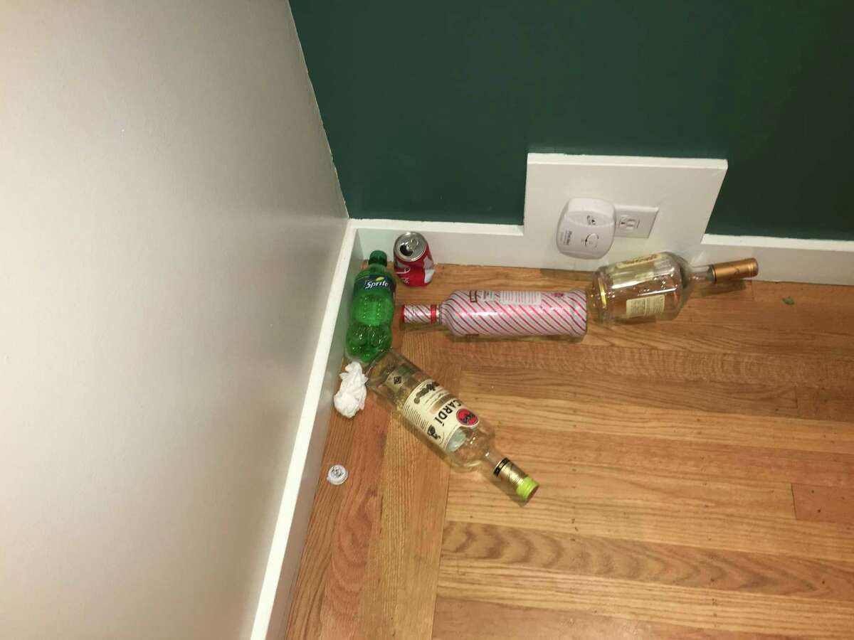 Alcohol bottles, soda cans and more litter the home of Jim Santi Owen and Reshma Vasanwala.