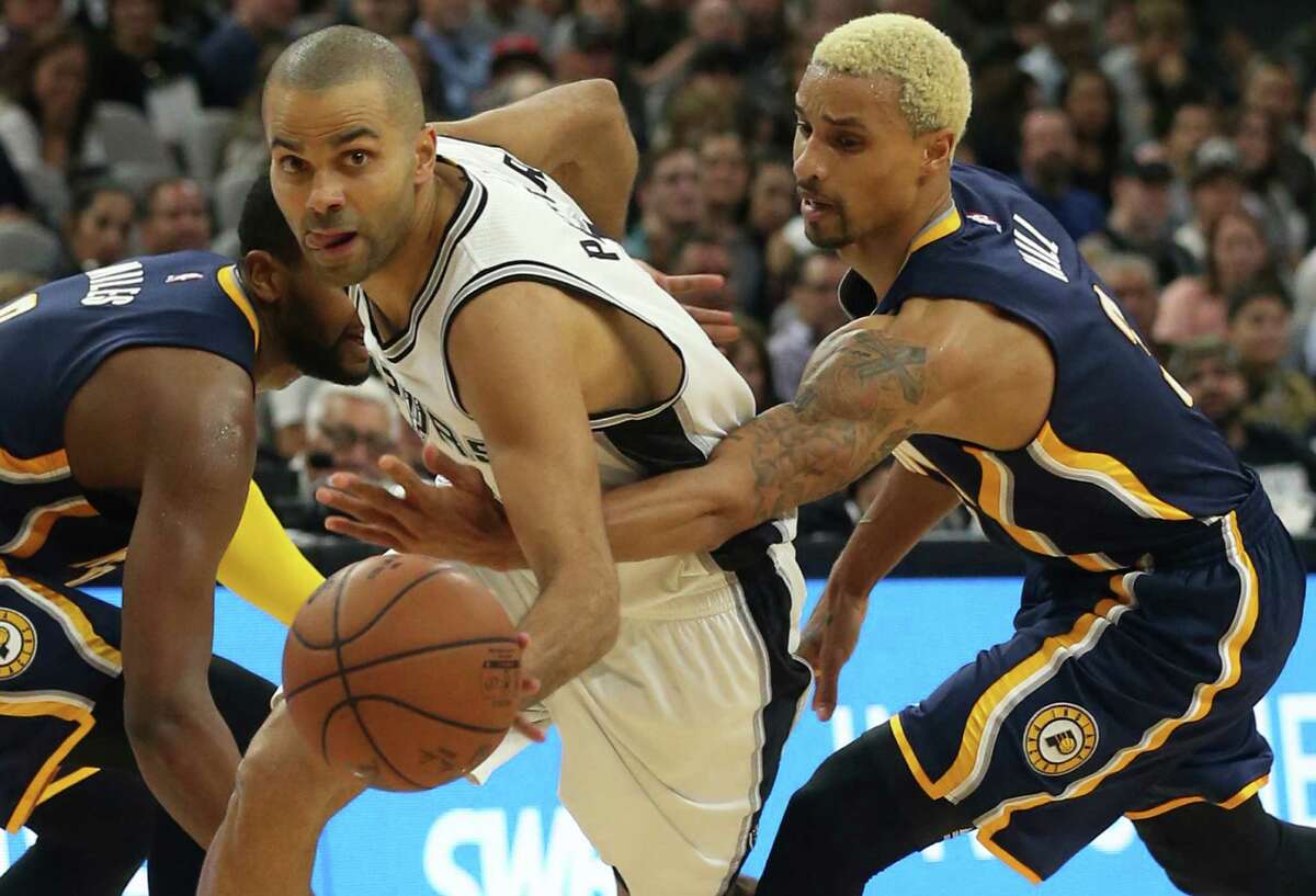 Indiana Pacers' George Hill attempts to steal the ball from San Antonio Spurs' Tony Parker during the second half at the AT&T Center, Monday, Dec. 21, 2015. The Spurs won, 106-92.