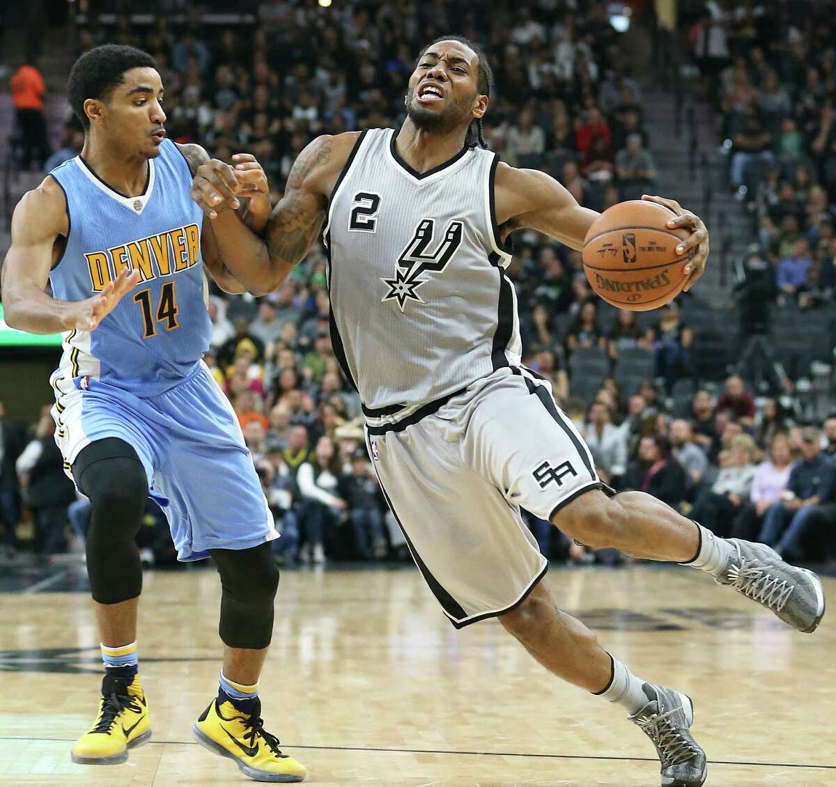 Kawhi Leonard tries a Manu style bump against Gary Harris as the Spurs host the Denver Nuggets at the AT&T Center on December 27, 2015.