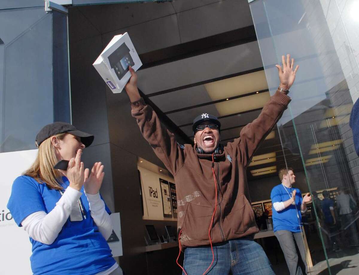 Carlos Suarez of Rye, NY, reacts with a shout as he leaves the Apple store on Greenwich Ave. after purchasing an iPad Saturday morning, April 3rd, 2010, Greenwich, Conn.