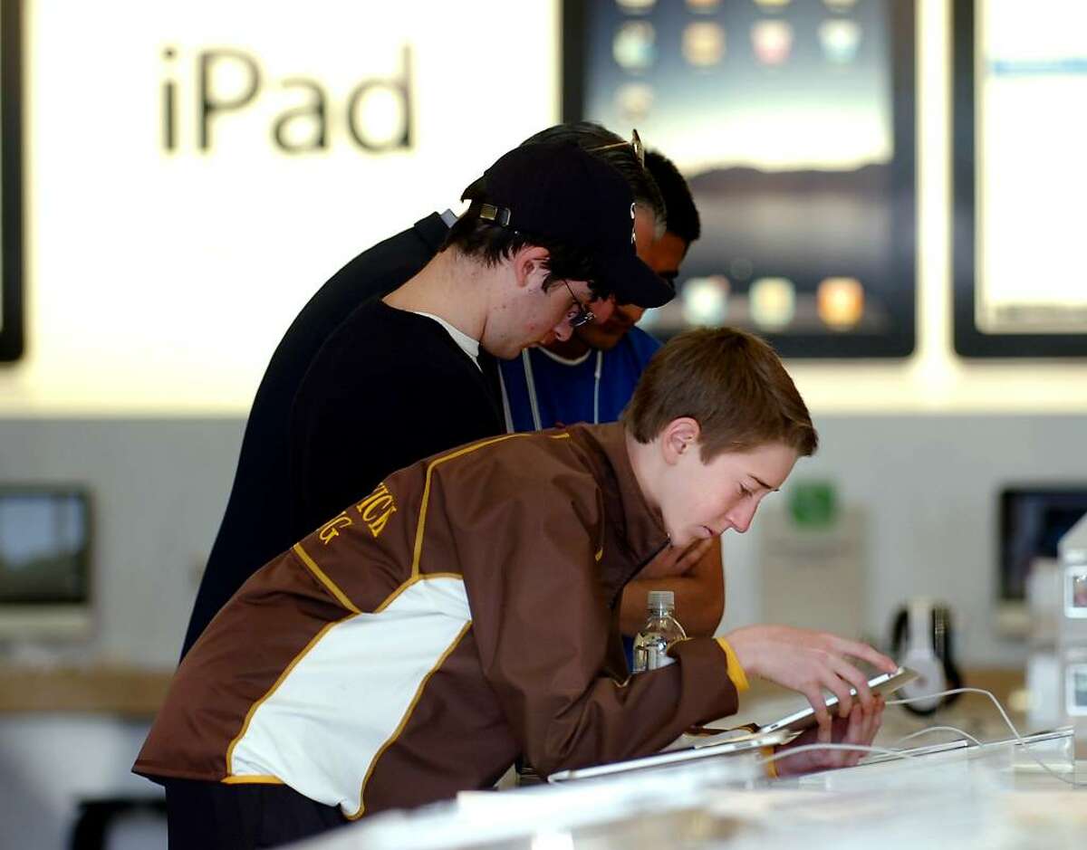 Henry Baker, 15, of Greenwich,Conn., inside the Apple store on Greenwich Ave., using one of the brand new display model iPads, Saturday morning, April 3rd, 2010.