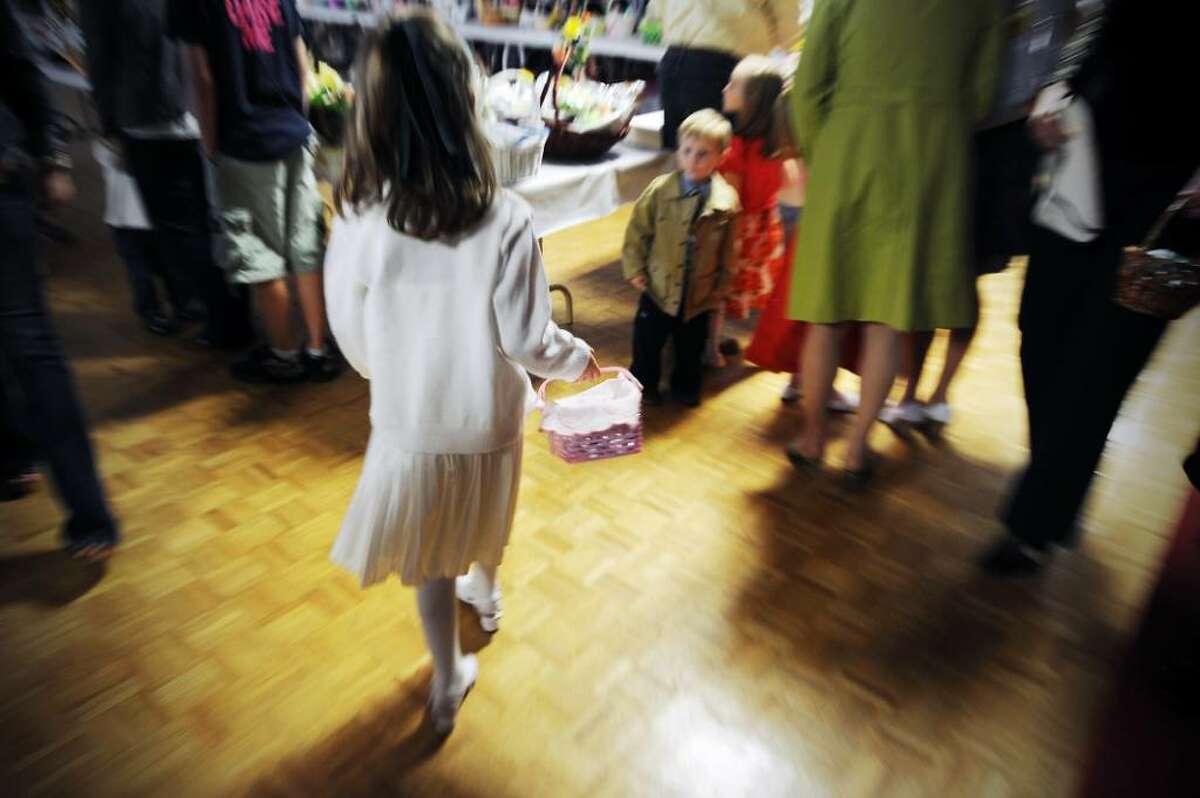 Children arrive with their baskets for the traditional Easter blessing of the food at Holy Name of Jesus Church in Stamford, Conn. on Saturday April 3, 2010