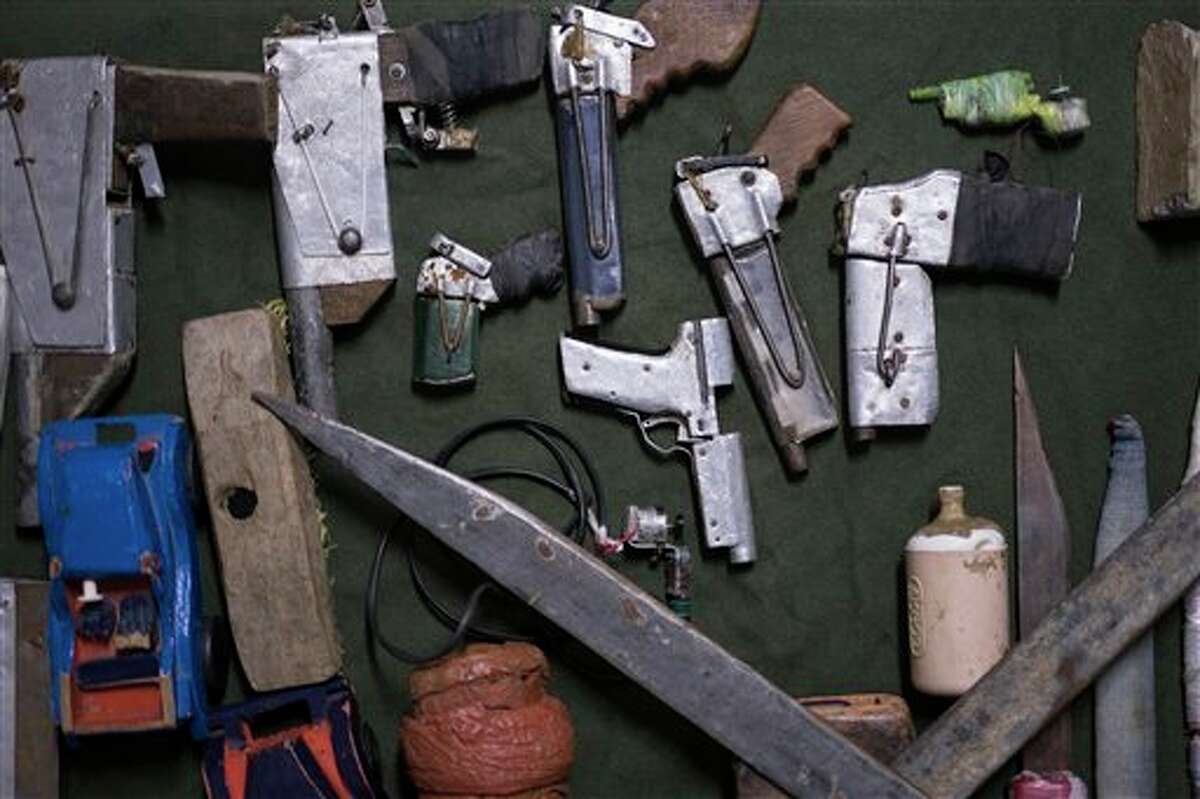 In this Dec. 1, 2015 photo, handmade weapons and tools found in inmates' cells lay on display at the Central Prison in Porto Alegre, Brazil. A recently installed scanner has reduced the number of cell phones, drugs and razor blades that are smuggled into the prison by visiting relatives. But many of these items are often thrown over the prison walls and retrieved by waiting inmates.