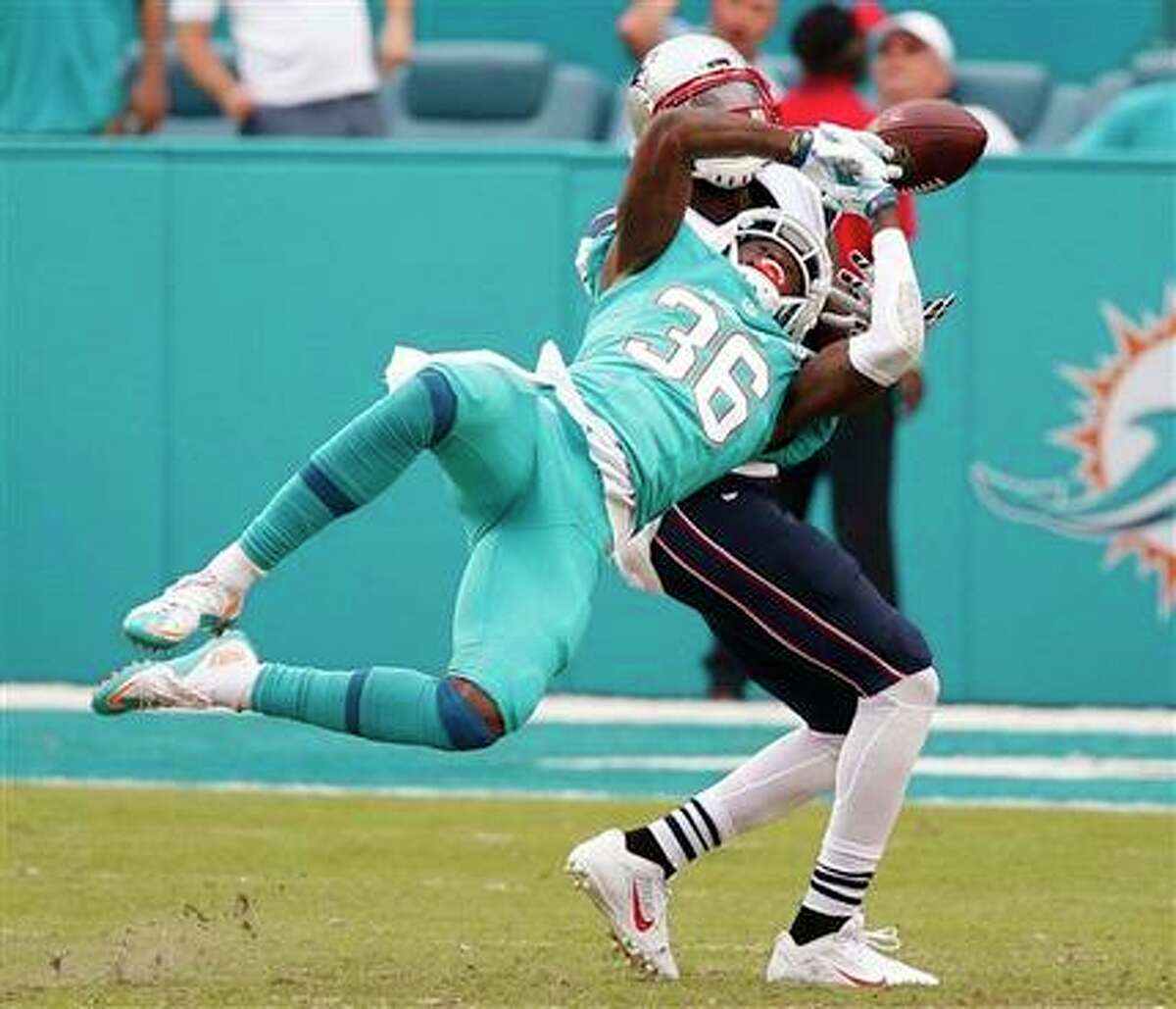 Miami Dolphins defensive back Tony Lippett defends New England Patriots receiver Brandon LaFell on Dec. 3, 2016 in Miami.
