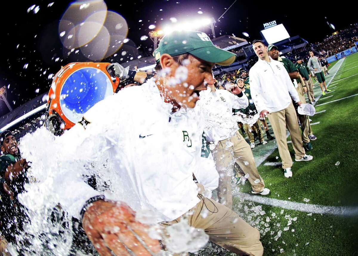 Head coach Art Briles of the Baylor Bears has water dumped on him after the Russell Athletic Bowl game against the North Carolina Tar Heels at Orlando Citrus Bowl on Dec. 29, 2015 in Orlando, Florida.
