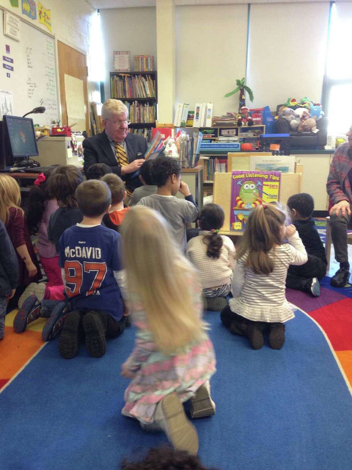 Interim Superintendent James Connelly starts his first day on the job reading to students in Brie O'Brien's class at the Apples preschool program.