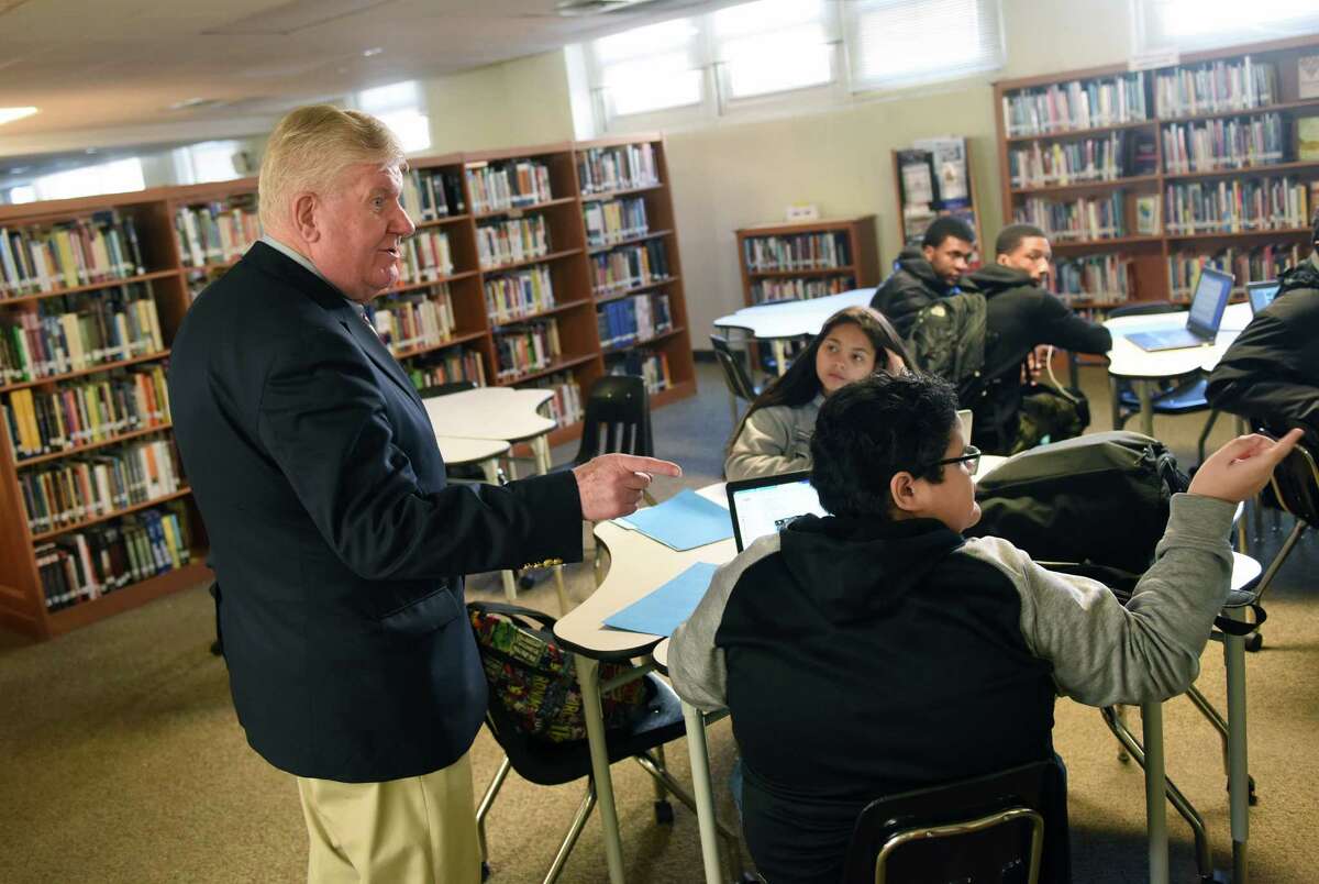 New Interim Stamford Superintendent of Schools James Connelly chats with students in the media center during a tour of Stamford High School in Stamford, Conn. Monday, Jan. 4, 2016. Connelly, who served as Superintendent of Bridgeport Schools from 1981-2000, is replacing former Superintendent Dr. Winifred Hamilton, who retired in May in the wake of several teacher misconduct scandals.