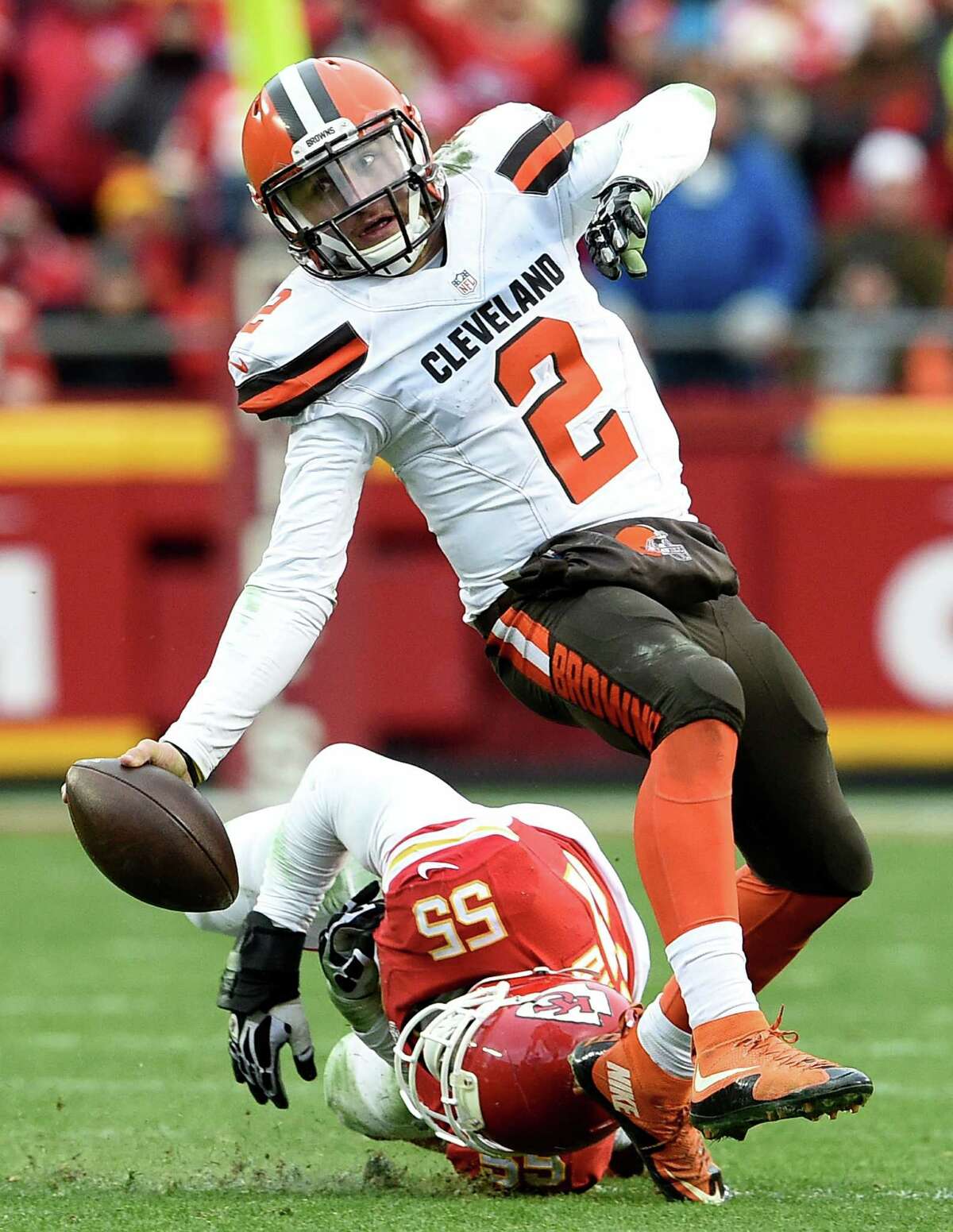 Cleveland Browns quarterback Johnny Manziel loses his balance as Kansas City Chiefs linebacker Dee Ford dives for his feet during the fourth quarter on Dec. 27, 2015, at Arrowhead Stadium.