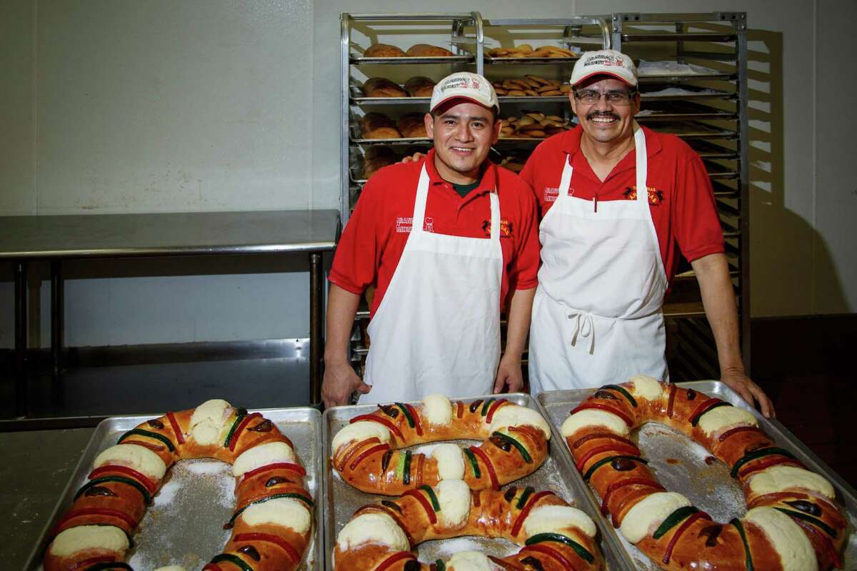 Carlos Marin, left, and Juan Alonso stand in front of a table of Rosca de Reyes at Arandas Bakery on 9803 Gulf Freeway.