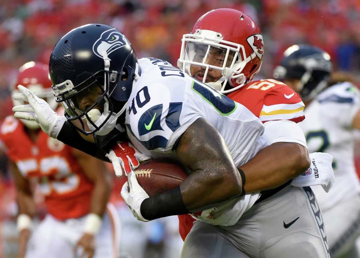 Seattle Seahawks fullback Derrick Coleman (40) is tackled by Kansas City Chiefs inside linebacker Derrick Johnson (56) during the first half of an NFL football game at Arrowhead Stadium in Kansas City, Mo., Friday, Aug. 21, 2015. (AP Photo/Ed Zurga)