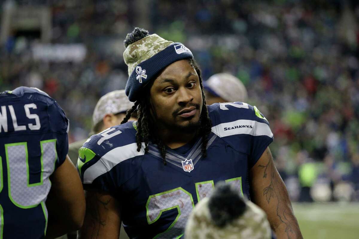 Seattle Seahawks running back Marshawn Lynch talks to teammates on the sideline in the second half of an NFL football game against the Arizona Cardinals, Sunday, Nov. 15, 2015, in Seattle.