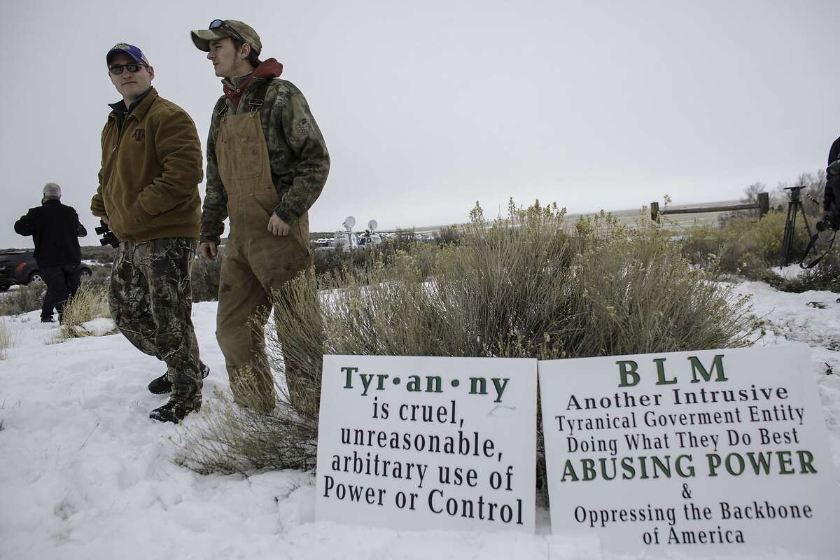 Members of an armed anti-government militia, monitor the entrance to the Malheur National Wildlife Refuge Headquarters near Burns, Oregon January 5, 2016. The occupation of a wildlife refuge by armed protesters in Oregon reflects a decades-old dispute over land rights in the United States, where local communities have increasingly sought to take back federal land. While the standoff in rural Oregon was prompted by the jailing of two ranchers convicted of arson, experts say the issue at the core of the dispute runs much deeper and concerns grazing or timber rights as well as permits to work mines on government land in Western states. AFP PHOTO / ROB KERRROB KERR/AFP/Getty Images