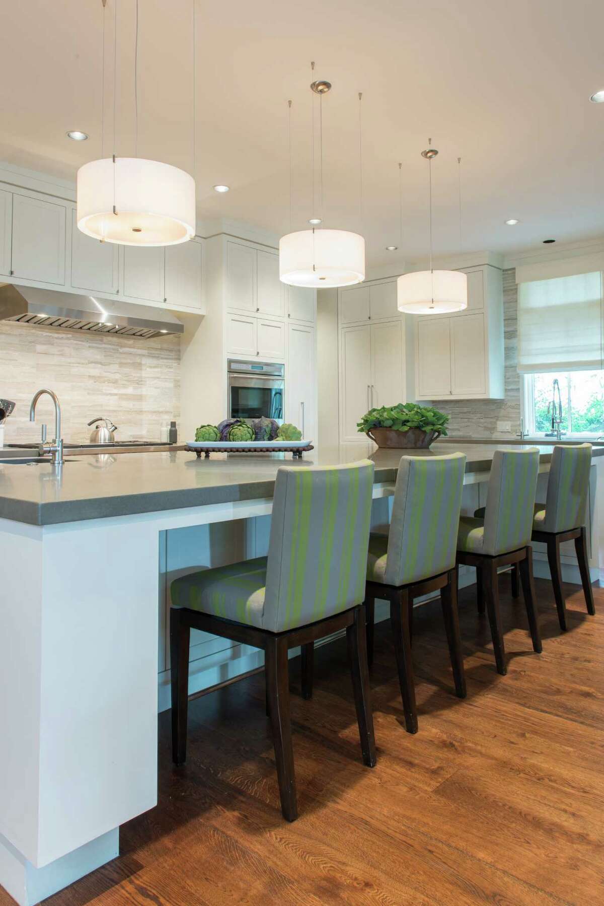 At the kitchen island, the custom-made barstools are designed to swivel - a feature Noelle Reed requested so her triplets wouldn't tip their stools backward when they pushed back from the counter.