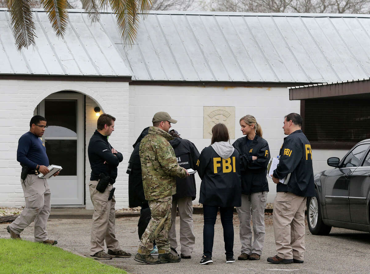 F.B.I. agents stand by the front door of a home located at 3003 Jupe Drive on San Antonio's South East Side where it is alleged that Bandidos Motocycle Club leader John X. Portillo lives. The agency said Portillo and the club's sergeant at arms, Justin Cole Forster, were taken into custody in San Antonio.
