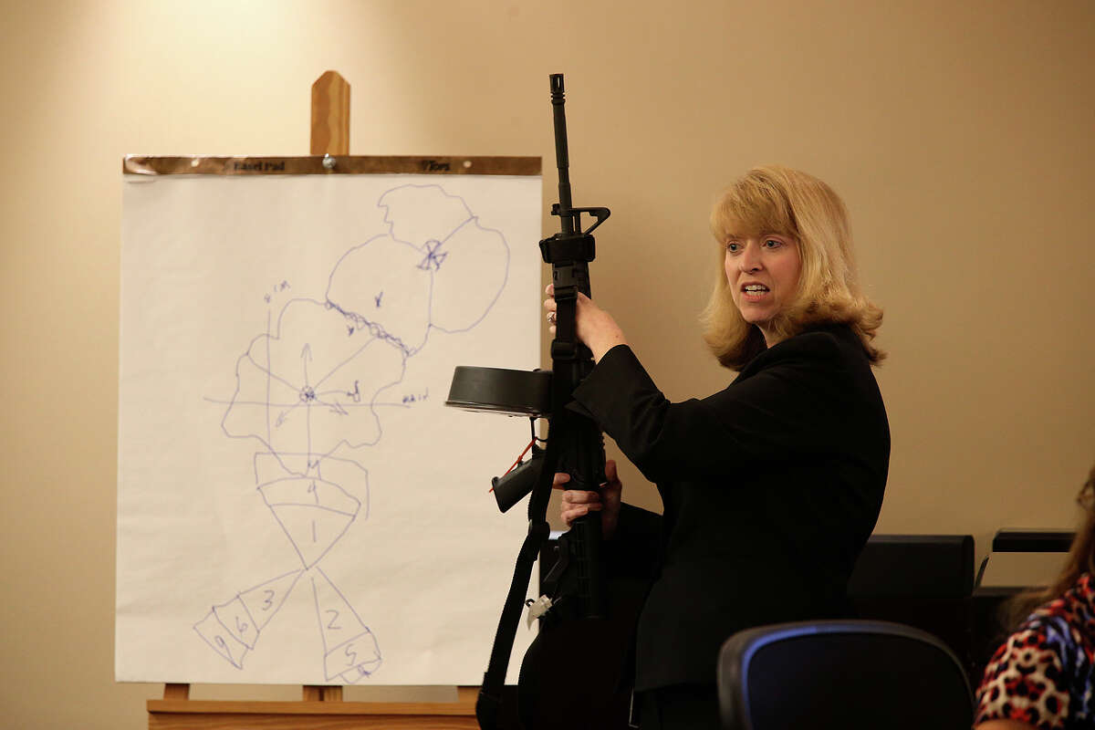 Prosecutor Julie Wright brings out the weapon used in the murder of Bexar County Sheriff's Sgt. Kenneth Vann, during closing arguments in the punishment phase of the capital murder trial of Mark Anthony Gonzalez in the Bexar County 175th State Criminal District Court, Monday, Oct. 19, 2015. Gonzalez was convicted in the Vann?•s murder in May of 2011.
