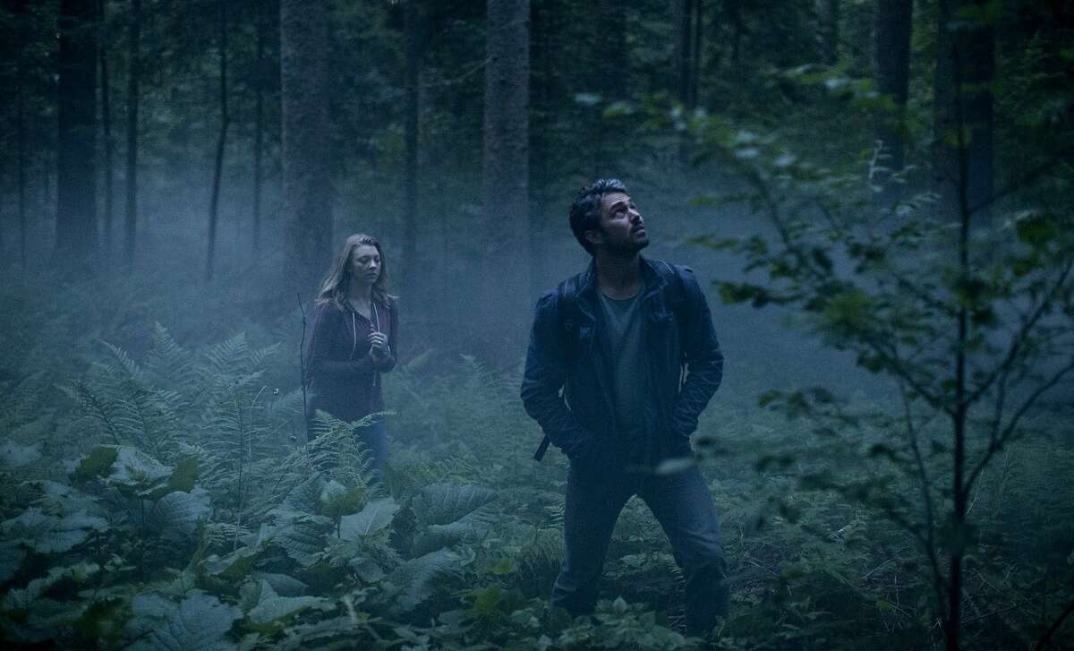 This photo provided by Gramercy Pictures shows, Natalie Dormer, left, as Sara Price, and Taylor Kinney as Aiden in Jason Zada's "The Forest," a Gramercy Pictures release. The movie opens in U.S. theaters on Jan. 8, 2016. (James Dittiger/Gramercy Pictures via AP)