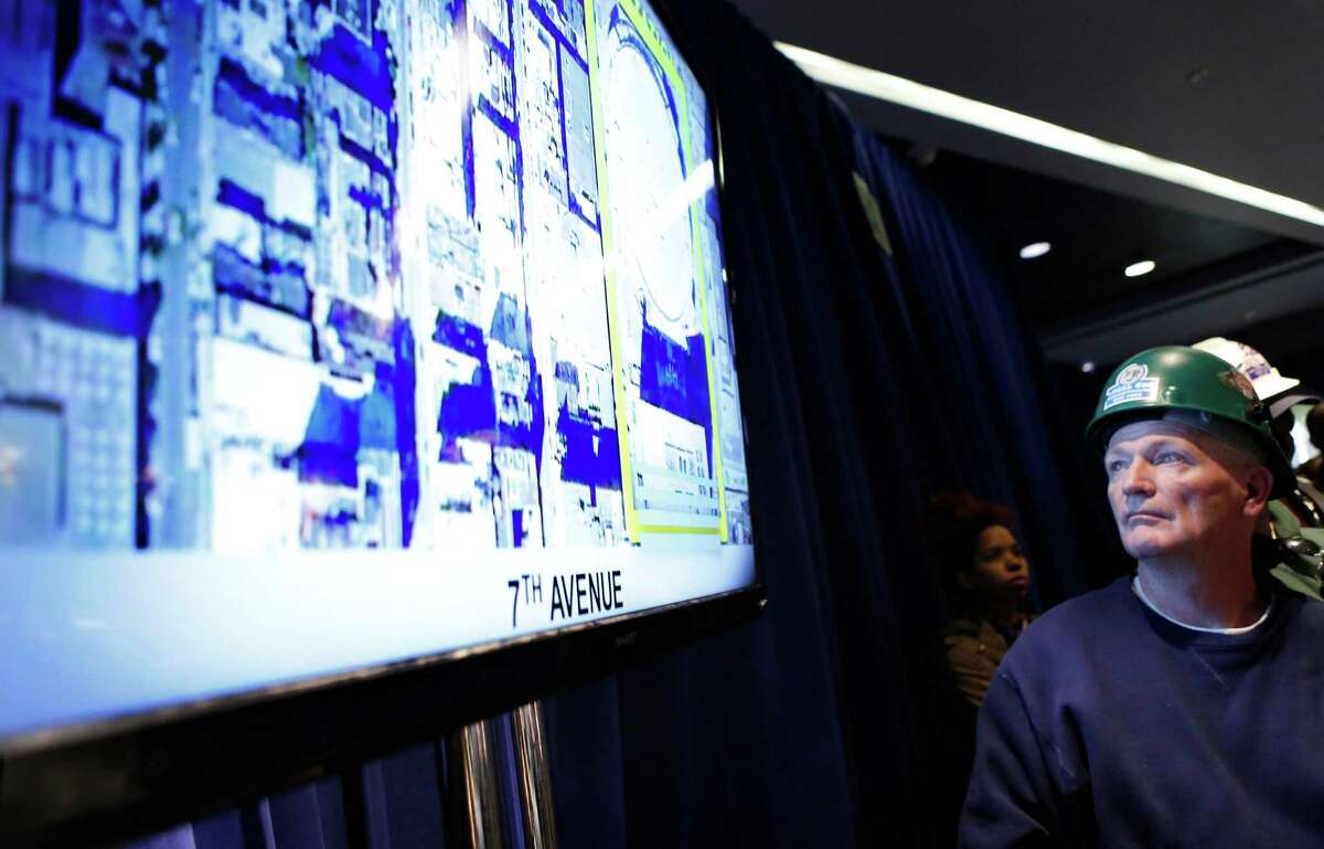 A construction worker looks at plans for the overhaul of Pennsylvania Station during a press conference led by New York Gov. Andrew Cuomo, Wednesday, Jan. 6, 2016, in New York. Cuomo announced that work will commence immediately on the overhaul of Pennsylvania Station at Madison Square Garden, Wednesday, Jan. 6, 2016, in New York. (AP Photo/Kathy Willens)