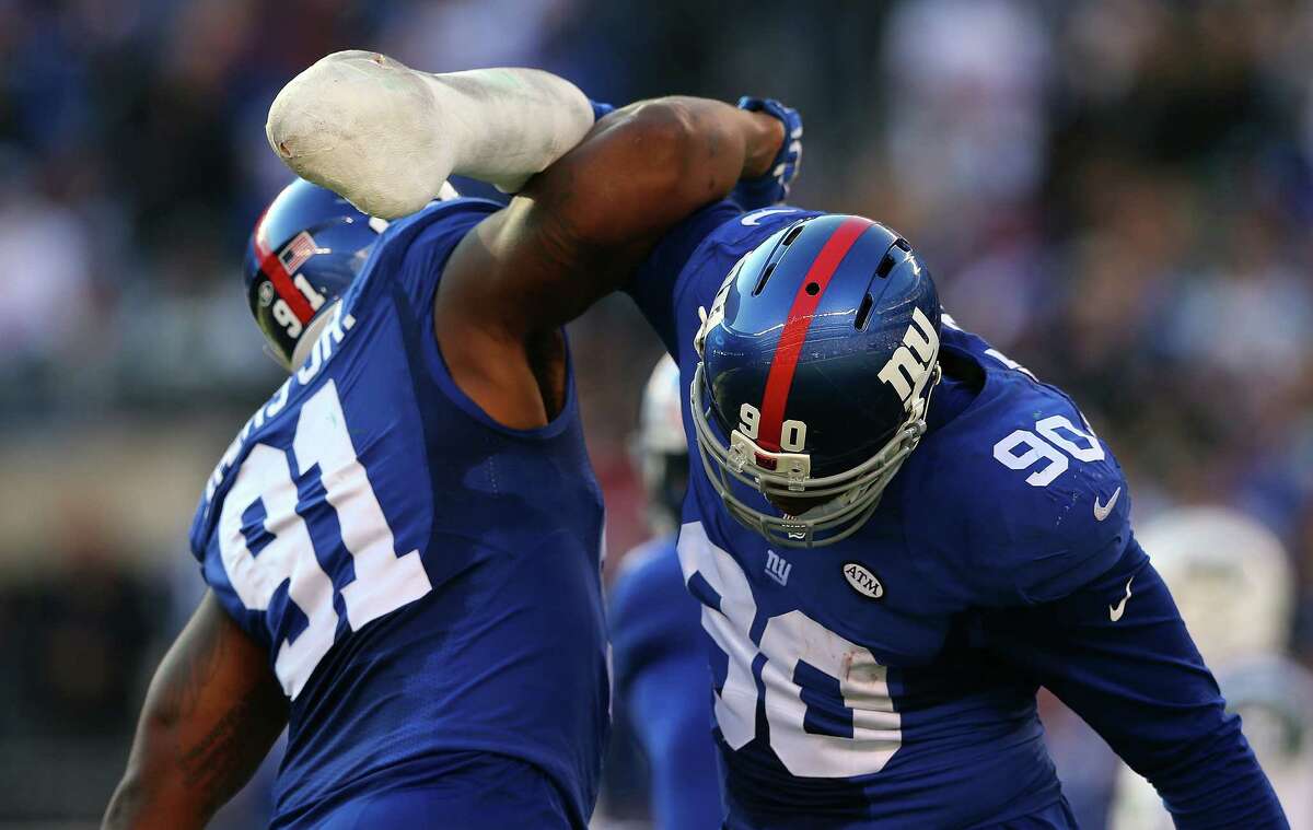 EAST RUTHERFORD, NJ - DECEMBER 06: Robert Ayers #91 and Jason Pierre-Paul #90 of the New York Giants celebrate after a play against the New York Jets at MetLife Stadium on December 6, 2015 in East Rutherford, New Jersey. (Photo by Elsa/Getty Images) ORG XMIT: 587435561