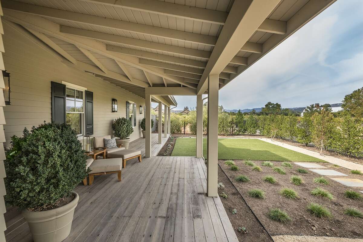 The 1.5-acre lot offers drought-tolerant plantings, a hobby vineyard and expansive patios.