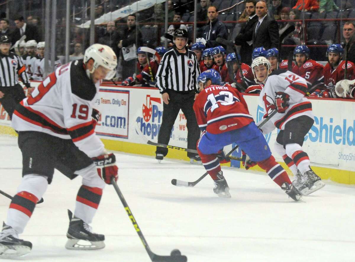 Devils Mike Sislo, left, gets a pass from Max Novak during their hockey game against St. John's at the Times Union Center on Wednesday Dec. 2, 2015 in Albany, N.Y. (Michael P. Farrell/Times Union)