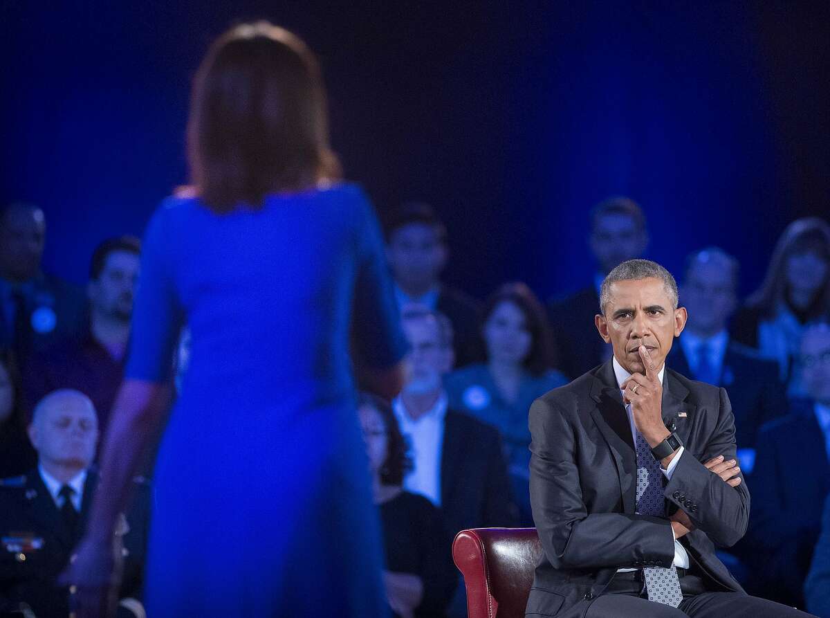 President Barack Obama, right, listens to a question from Taya Kyle, left, widow of U.S. Navy SEAL Chris Kyle, during a CNN televised town hall meeting hosted by Anderson Cooper at George Mason University in Fairfax, Va., Thursday, Jan. 7, 2016. Obama's proposals to tighten gun controls rules may not accomplish his goal of keeping guns out of the hands of would-be criminals and those who aren't legally allowed to buy a weapon. In short, that's because the conditions he is changing by executive action are murkier than he made them out to be. (AP Photo/Pablo Martinez Monsivais)
