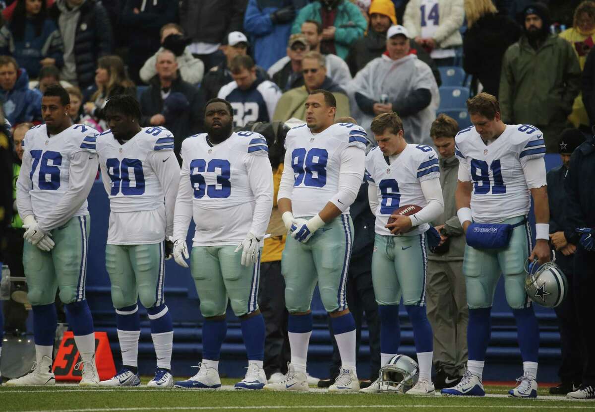 Dallas Cowboys players stand during a moment of silence for victims of Dallas-area tornadoes before the game against the Buffalo Bills on Dec. 27. The Cowboys experienced another disappointing season, and a reader says it is time to clean house.