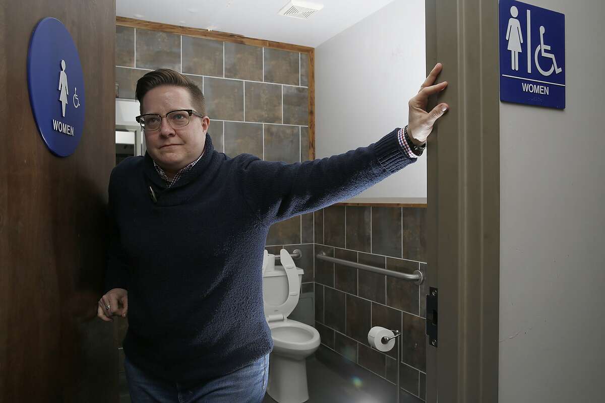 Local LGBQ activist Beck Lucas stands by a single-room bathroom at South Paw BBQ in San Francisco, California, on Friday, January 8, 2015. Next Tuesday supervisor David Campos will introduce legislation that requires the city to make all single-room bathrooms gender neutral.