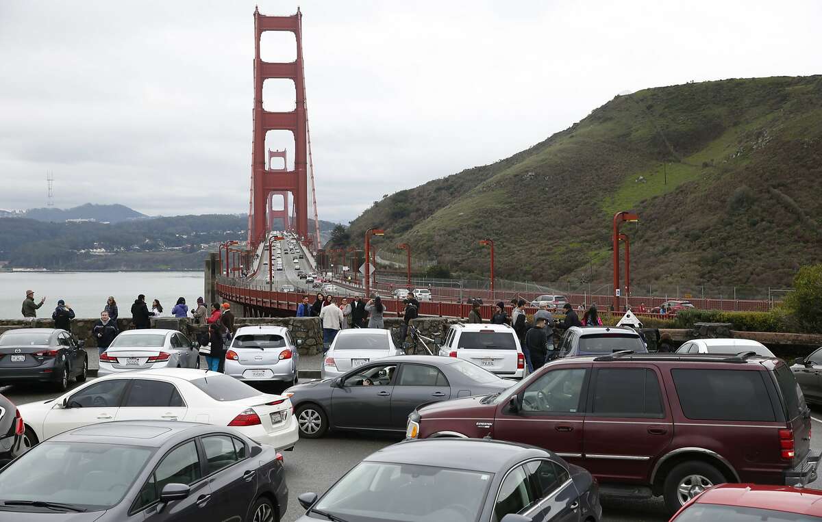 Motorists waiting for parking spaces to open up create a logjam at the north vista point of the Golden Gate Bridge in Sausalito, Calif. on Saturday, Jan. 9, 2016. 