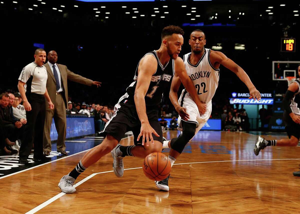 NEW YORK, NY - JANUARY 11: Kyle Anderson #1 of the San Antonio Spurs drives against Markel Brown #22 of the Brooklyn Nets during their game at the Barclays Center on January 11, 2016 in New York City. NOTE TO USER: User expressly acknowledges and agrees that, by downloading and/or using this Photograph, user is consenting to the terms and conditions of the Getty Images License Agreement.