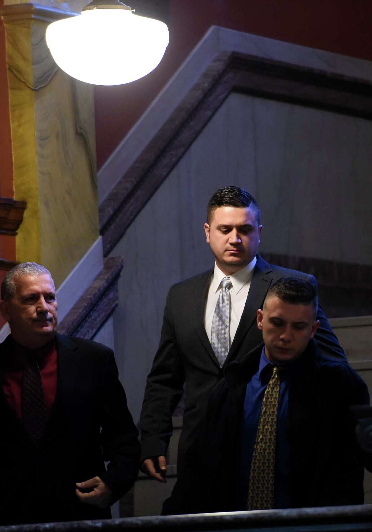 Nicholas Pontore, center, the 30-year-old former Watervliet cops accused of protecting a gang-related narcotics ring and buying cocaine while on the job, arrives at the Rensselaer County Courthouse Monday, Jan. 11, 2016, in Troy, N.Y. Pontore took a plea deal and was taken to jail after a conviction on 4th degree possession of a controlled substance. (Skip Dickstein/Times Union)